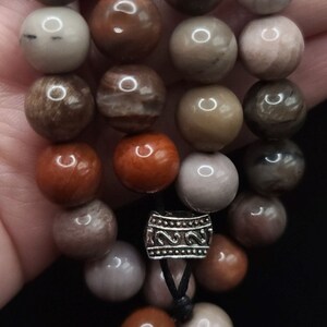 Petrified Wood Komboloi - Greek Worry Beads
Each piece is hand assembled with 100% natural stones and consists of  25 beads - 21 in the body - 4 at the top with an antique silver plated shield.