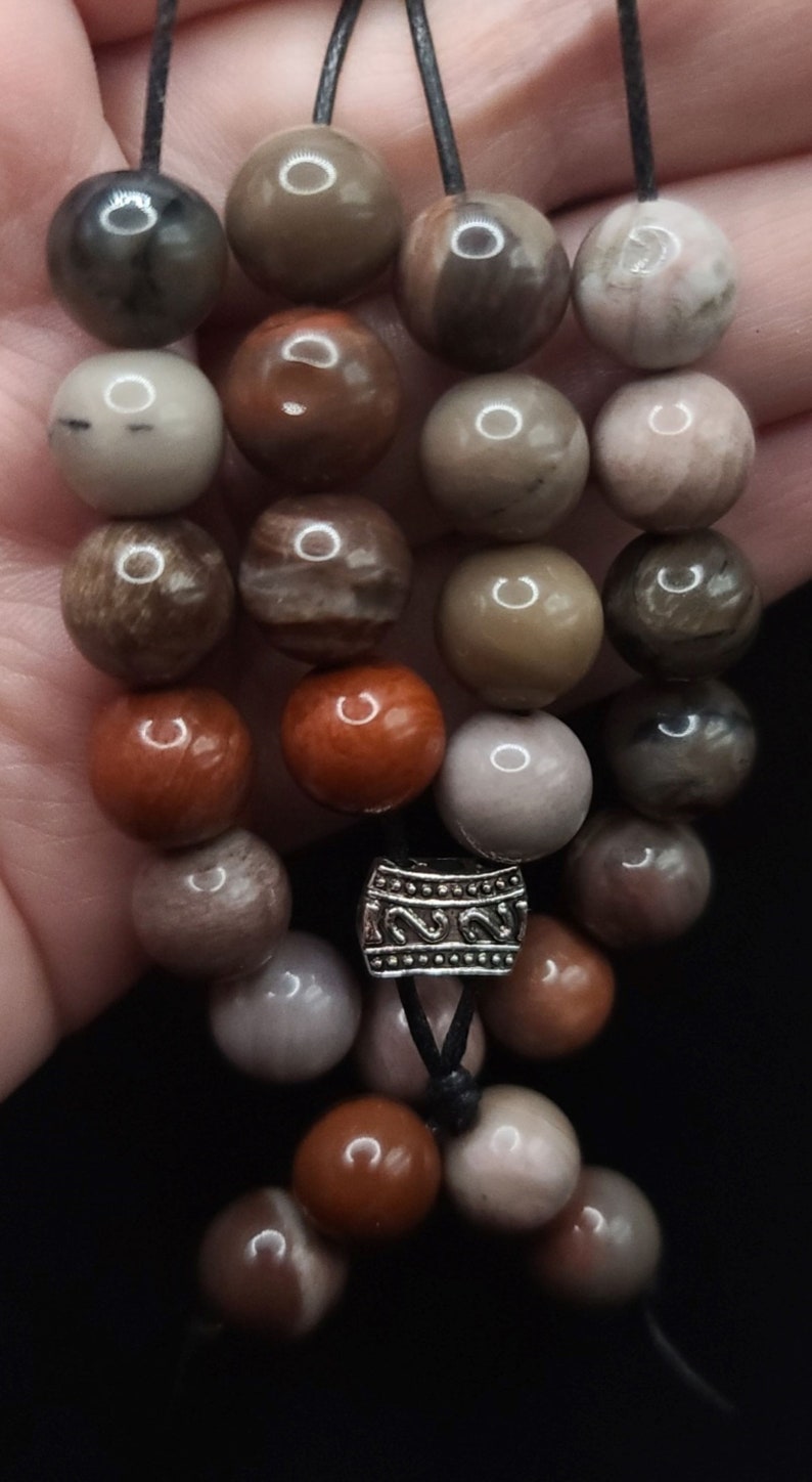 Petrified Wood Komboloi - Greek Worry Beads
Each piece is hand assembled with 100% natural stones and consists of  25 beads - 21 in the body - 4 at the top with an antique silver plated shield.