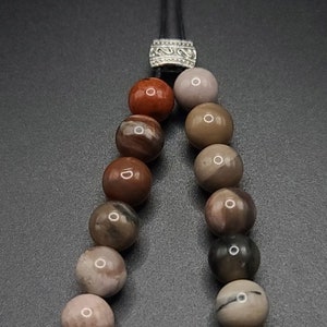 Petrified Wood Komboloi - Greek Worry Beads
Each piece is hand assembled with 100% natural stones and consists of  25 beads - 21 in the body - 4 at the top with an antique silver plated shield.