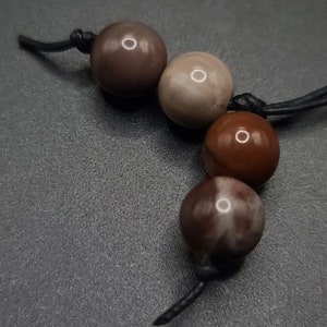 Petrified Wood Komboloi - Greek Worry Beads
Each piece is hand assembled with 100% natural stones and consists of  25 beads - 21 in the body - 4 at the top with an antique silver plated shield.