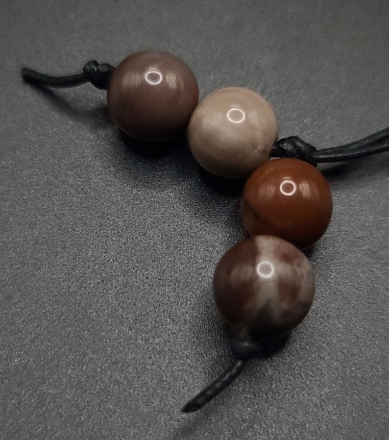 Petrified Wood Komboloi - Greek Worry Beads
Each piece is hand assembled with 100% natural stones and consists of  25 beads - 21 in the body - 4 at the top with an antique silver plated shield.