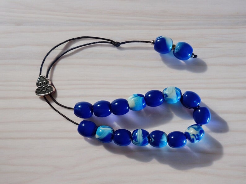 A unique 100% handmade high quality worry beads / Greek Kompoloi in beautiful blue marble color with 15 or 17 beads (you can choose from variations) and with three cylindrical decorations at the end: Two stainless steel and one bronze!