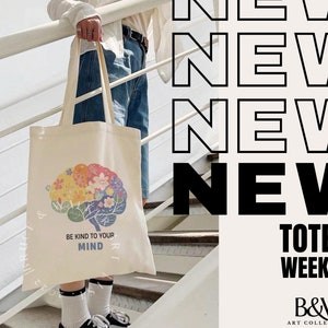 May include: A white tote bag with a colorful brain design and the text "Be Kind to Your Mind". The bag is being held by a person standing on a set of stairs. The text "NEW Totes WEEKLY B&W ART COLLECTIVE" is displayed on the right side of the image.