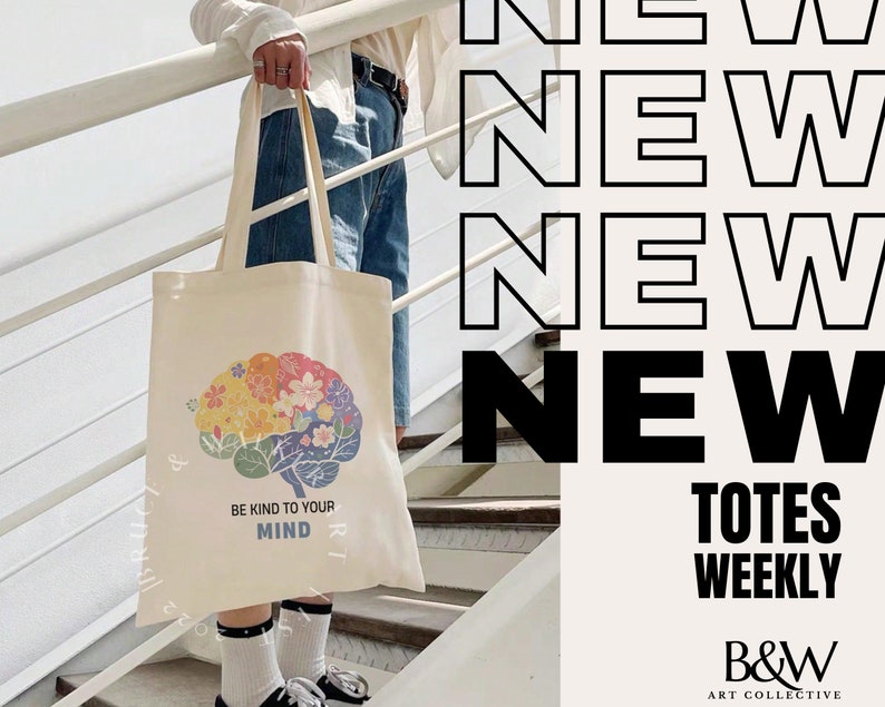 May include: A white tote bag with a colorful brain design and the text "Be Kind to Your Mind". The bag is being held by a person standing on a set of stairs. The text "NEW Totes WEEKLY B&W ART COLLECTIVE" is displayed on the right side of the image.