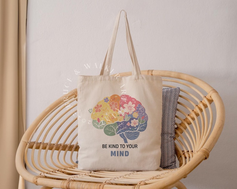 May include: A beige tote bag with a colorful brain design and the text "Be kind to your mind".