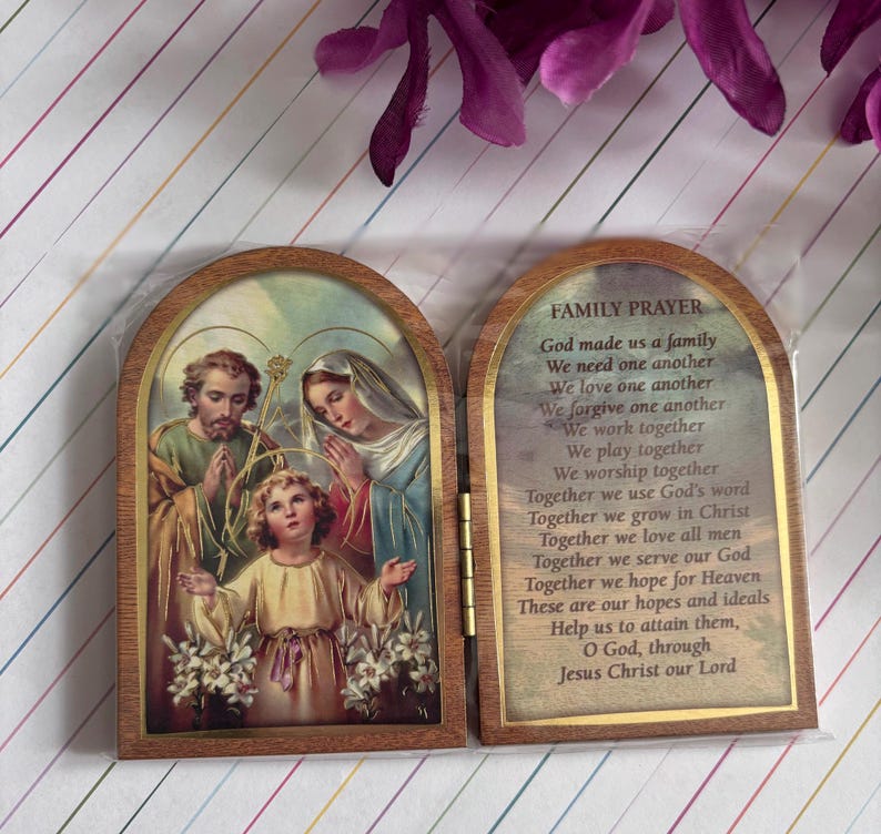 Puede incluir: Una caja de oraci&oacute;n de madera con un frente con bisagras. El frente presenta una pintura de la Sagrada Familia, con Jes&uacute;s, Mar&iacute;a y Jos&eacute;. La parte posterior de la caja tiene una oraci&oacute;n para las familias, que dice: "Dios nos hizo una familia, Nos necesitamos unos a otros, Nos amamos unos a otros, Nos perdonamos unos a otros, Trabajamos juntos, Jugamos juntos, Adoramos juntos, Juntos usamos la palabra de Dios, Juntos crecemos en Cristo, Juntos amamos a todos los hombres, Juntos servimos a nuestro Dios, Juntos esperamos el Cielo, Estas son nuestras esperanzas e ideales, Ay&uacute;danos a alcanzarlas, Oh Dios, a trav&eacute;s de Jesucristo nuestro Se&ntilde;or."
