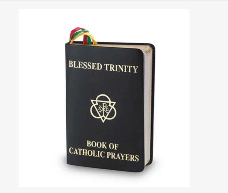 May include: A black book titled "BLESSED TRINITY" with gold lettering and a gold emblem. The book is labeled "BOOK OF CATHOLIC PRAYERS" and has a colorful ribbon bookmark. The book's edges are gilded.