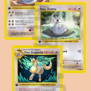 May include: Three Pokemon trading cards featuring Thicc Dragonair, Thicc Dratini, and Thicc Dragonite. The cards are yellow with black borders and feature illustrations of the Pokemon. The cards have stats and abilities printed on them.