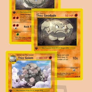 May include: A set of four Pokemon trading cards featuring Thicc Graveler, Thicc Geodude, Thicc Golem, and Boulder Butt Roll. The cards are yellow with orange borders and feature illustrations of the Pokemon.