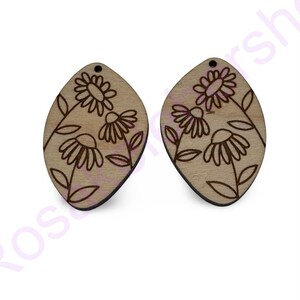 May include: A pair of wooden earrings with a floral design. The earrings are shaped like a teardrop and have a hole at the top for hanging.