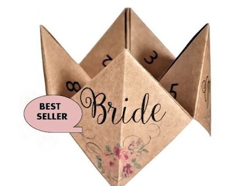 Op de afbeelding: Een bruine papieren waarzegster met het woord "Bride" in zwarte cursieve letters. De waarzegster heeft de nummers 2, 3, 5 en 8 op de buitenste flappen geschreven. De waarzegster heeft een bloemmotief met roze bloemen.