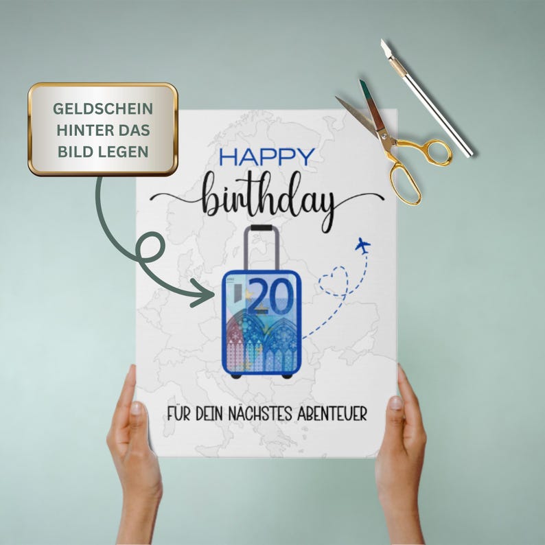 May include: A white card with the text "Happy birthday" and a blue suitcase with a 20 euro bill inside. The suitcase is on a map of the world. The text "For your next adventure" is below the suitcase. The text "Geldchein hinter das Bild legen" is in a gold box at the top of the card.