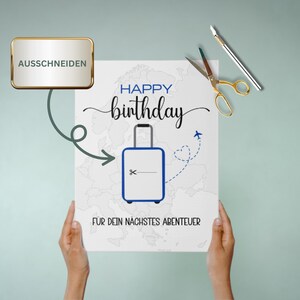 May include: A white card with a blue suitcase and a world map in the background. The card says "Happy birthday" and "For your next adventure".