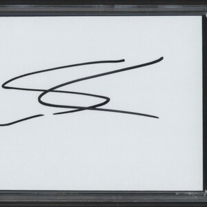 May include: A white card with a black signature, "Sofia Carson", in a black frame with a PSA/DNA Certified Authentic Auto label.