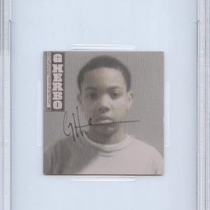 May include: A CD insert featuring a grayscale image of a person with the name "G Herbo" and an autograph. The insert is encased in a clear plastic holder with a blue and white label at the top that reads "CD INSERT G HERBO PSA/DNA CERTIFIED AUTHENTIC AUTO 85738030".