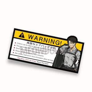 May include: A yellow and black warning sign with a cartoon character from the anime Attack on Titan. The sign reads "WARNING!  高度なエアバッグでも Children can be killed or seriously injured by the air bag. The back seat is the safest place for children. Never put a rear-facing child seat in the front. Always use seat belts and child restraints. See owner's manual for more information about air bags. Stay Alive. That's An Order, Watch The Road!"