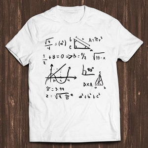 May include: A white t-shirt featuring black handwritten mathematical equations and formulas, including Pythagoras' theorem, the square root of 3, and the formula for the area of a circle. The equations are written in a casual, handwritten style.
