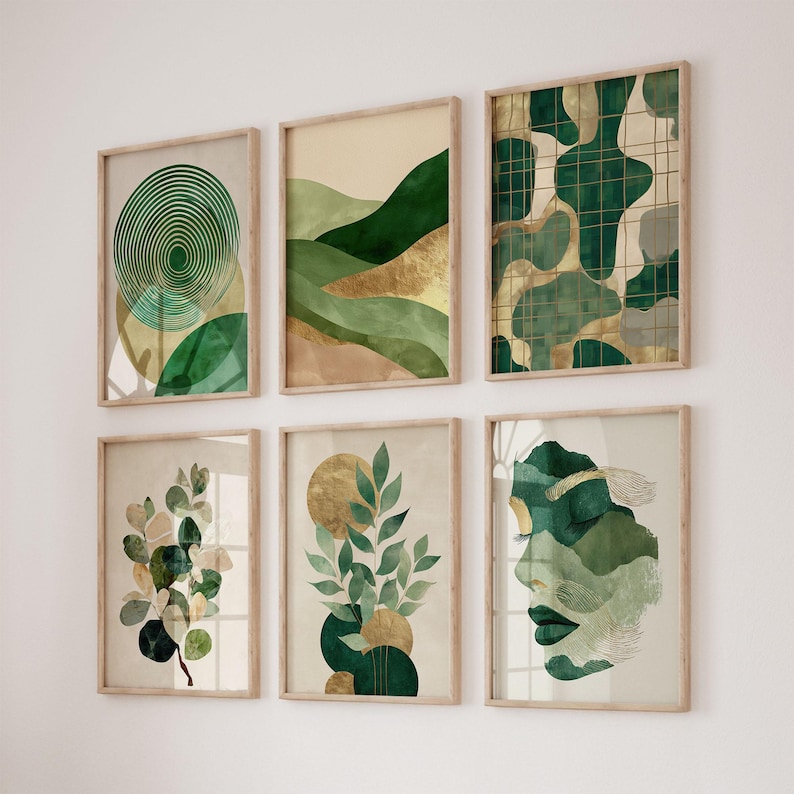 May include: Six framed art prints with abstract designs in shades of green, gold, and beige. The prints feature geometric shapes, landscapes, and botanical elements. The frames are made of light-colored wood, creating a cohesive gallery wall.