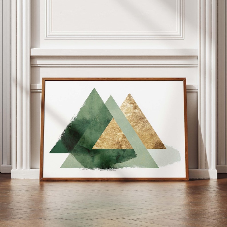 May include: A framed art print featuring three overlapping triangles in shades of green and gold against a white background. The artwork has a modern, abstract design with textured brushstrokes and a wooden frame.