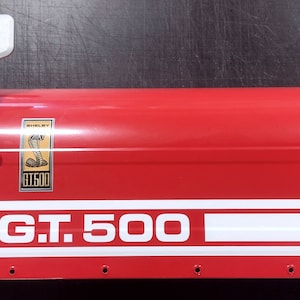 May include: Red mailbox with a white "GT. 500" stripe and a Shelby Cobra logo sticker.