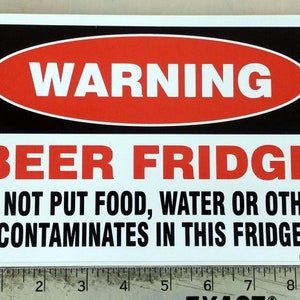 May include: A white sign with black and red text that reads "WARNING BEER FRIDGE DO NOT PUT FOOD, WATER OR OTHER CONTAMINATES IN THIS FRIDGE".