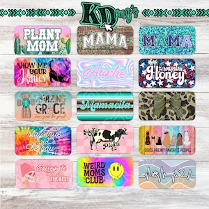 May include: A collection of rectangular decorative items with various designs and text. Designs include floral, animal, and inspirational quotes. Text includes "Plant Mom", "Mama", "Auntie", "Amazing Grace", and "Dogs are my favorite people".