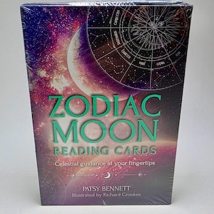 May include: A box of Zodiac Moon Reading Cards with a celestial design featuring a crescent moon, stars, and a zodiac wheel. The box is purple, black, and white with green text that reads "Zodiac Moon Reading Cards" and "Celestial guidance at your fingertips". The text "Patsy Bennett" and "Illustrated by Richard Crookes" is also on the box.