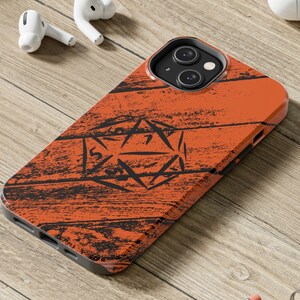 May include: Orange phone case with a black wood grain pattern and a black and white image of a 20-sided die.