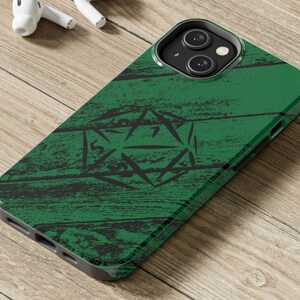 May include: Green phone case with a wood grain pattern and a black and white drawing of a 20-sided die.