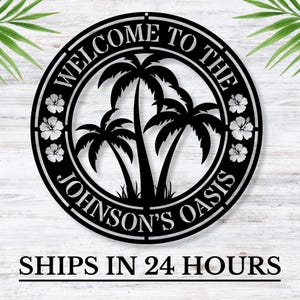 May include: Black metal sign with the text "Welcome to the Johnson's Oasis" surrounded by palm trees and hibiscus flowers.