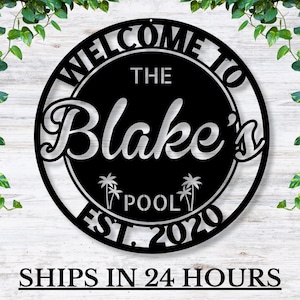 May include: Black metal welcome sign with white text that reads "Welcome to The Blake's Pool Est. 2020". The sign features palm trees and a circle design.