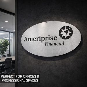 May include: Oval-shaped silver sign with the text "Ameriprise Financial" and a starburst logo. The sign is mounted on a dark gray textured wall. The sign is designed for offices and professional spaces.