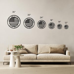 May include: Black metal wall art featuring the American flag design in a circular shape. The text "THE MCCOWNS EST 2015" is displayed around the flag. Available in various sizes, from 12 inches to 36 inches.