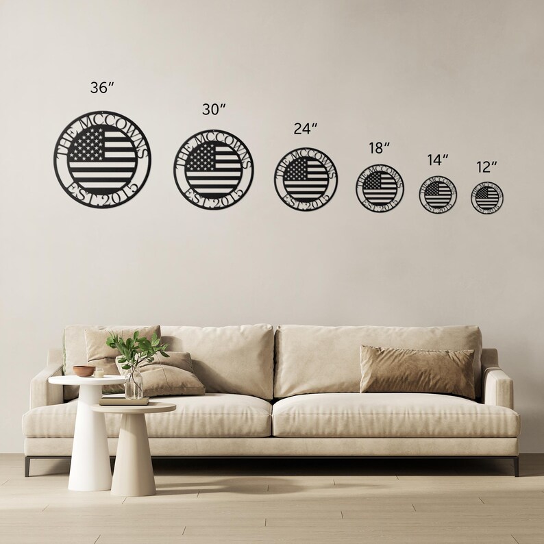 May include: Black metal wall art featuring the American flag design in a circular shape. The text "THE MCCOWNS EST 2015" is displayed around the flag. Available in various sizes, from 12 inches to 36 inches.