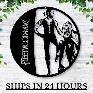 May include: Black and white metal wall art featuring a silhouette of two figures, a man and a woman, with the text "FLEETWOOD MAC" in a stylized font.