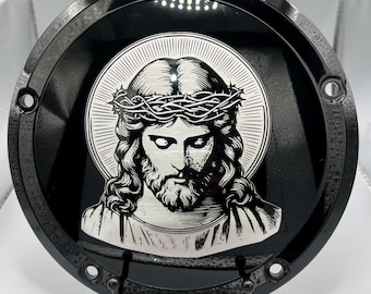May include: Black motorcycle cover with a silver image of Jesus wearing a crown of thorns.