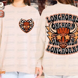 May include: A white sweatshirt with a red and black checkered heart featuring a bull with star-shaped sunglasses. The back of the sweatshirt has a red bull with star-shaped sunglasses and the text "Longhorns" repeated four times in a retro font.