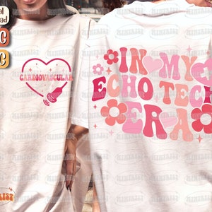 May include: Two white t-shirts with pink and red designs. The first shirt has a heart with the text "Cardiovascular" and a medical ultrasound image. The second shirt has the text "In My Echo Tech Era" with pink and red flowers.
