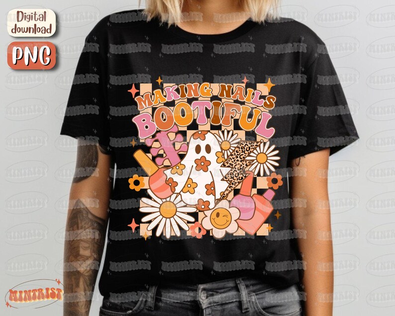 May include: Black t-shirt with a retro design that says "MAKING NAILS BOOTIFUL". The graphic includes a ghost, flowers, nail polish bottles, and a lightning bolt with a leopard print pattern. The design has a vintage, groovy aesthetic.