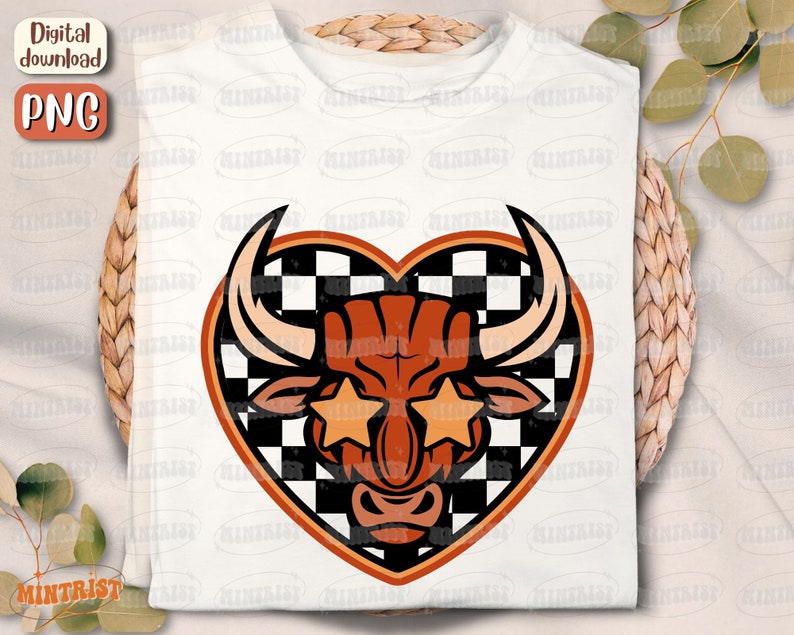 May include: A white t-shirt with a red and black checkered heart design featuring a bull with star-shaped sunglasses.