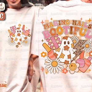 May include: White t-shirt featuring a retro design with a ghost, nail polish bottles, daisies, and the text "MAKING NAILS BOOTIFUL." The design includes a checkerboard pattern and a lightning bolt with a leopard print.