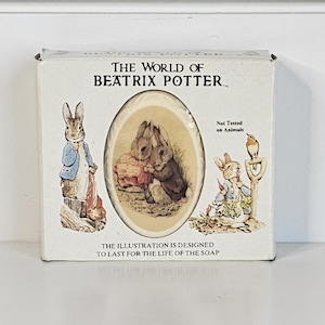 May include: A boxed soap featuring illustrations from "The World of Beatrix Potter." The box displays images of Peter Rabbit and other characters. The text on the box reads "Not Tested on Animals" and "The illustration is designed to last for the life of the soap."