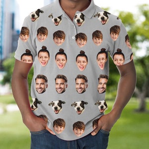 May include: A grey polo shirt with a repeating pattern of faces and dog heads. The faces include a man, a woman, and a child. The dog is a black and white spotted breed.