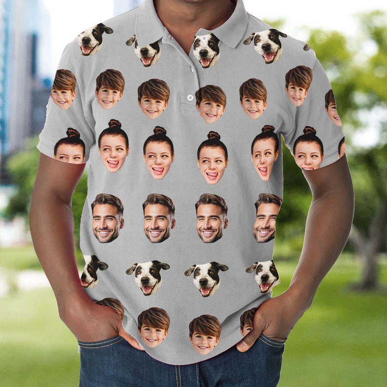May include: A grey polo shirt with a repeating pattern of faces and dog heads. The faces include a man, a woman, and a child. The dog is a black and white spotted breed.