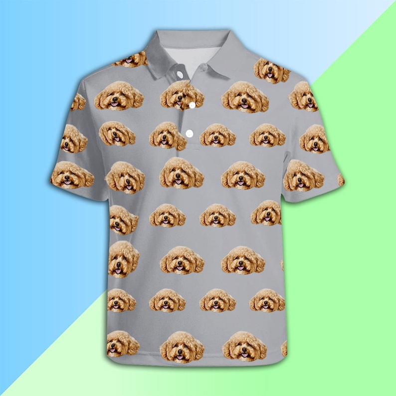 May include: A grey polo shirt with a repeating pattern of a brown and white dog's face.
