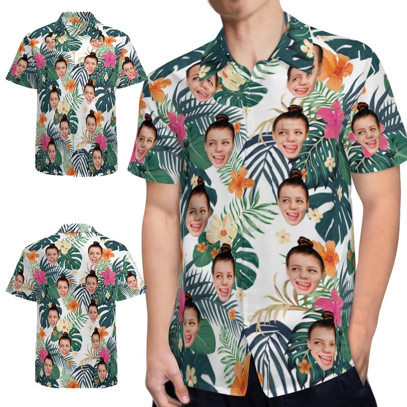 May include: A white button-down shirt with a tropical print featuring multiple faces. The shirt has short sleeves and a collared neckline.