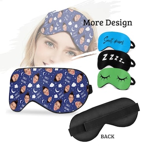 May include: A blue sleep mask with a pattern of clouds, stars, and moons. The mask has a white elastic band. The mask is shown with other sleep masks in different colors and patterns. The text "Sweet Dreams" is on the blue mask. The text "ZZZZ" is on the black mask. The text "Sweet dreams" is on the blue mask. The text "More Design" is on the image. The back of a black sleep mask is also shown.