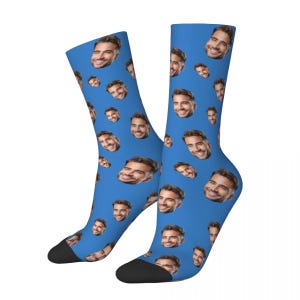 May include: A pair of blue socks with a repeated pattern of a man's face.