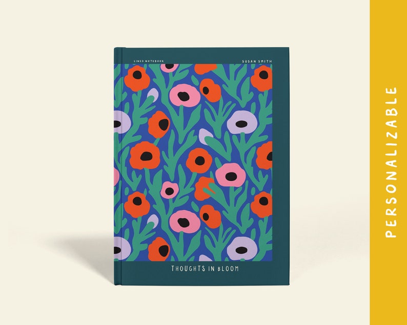May include: A notebook with a floral pattern. The cover has a blue backdrop with orange, pink, and purple flowers and green leaves. The text "THOUGHTS IN BLOOM" is at the bottom. The notebook is labelled "PERSONALIZABLE".
