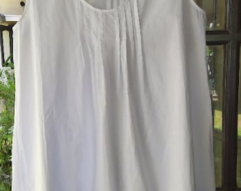 May include: A white sleeveless cotton nightgown with a gathered neckline and a lace trim around the bottom.